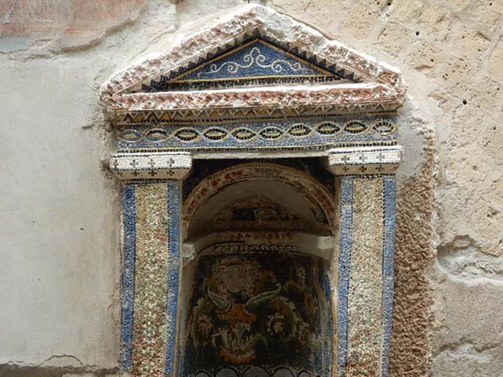 III.3 Herculaneum, May 2018. Detail of mosaic and shell-trimmed aedicula.Photo courtesy of Buzz Ferebee